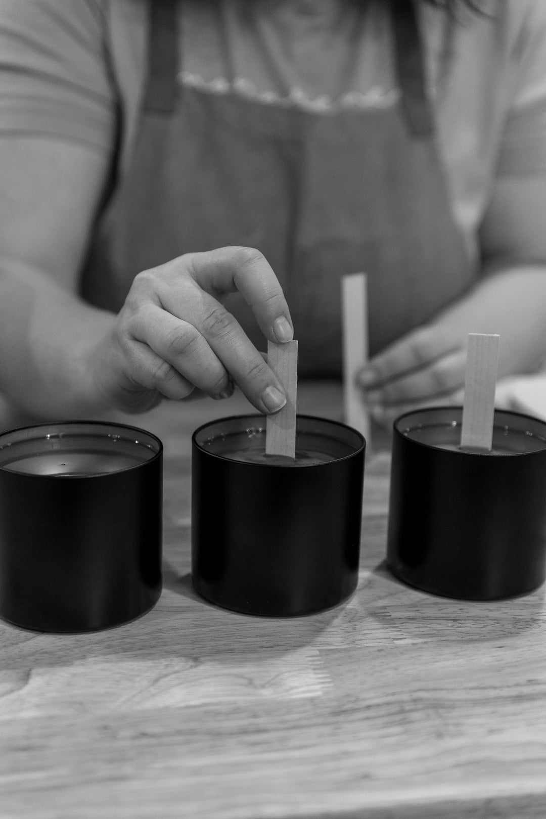 adding wooden wicks to poured candles