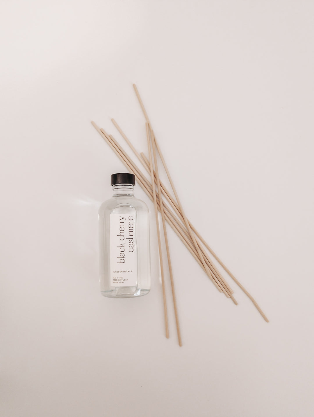 Black Cherry Cashmere Reed Diffuser in clear glass bottle with reeds by juneberryplace home fragrances