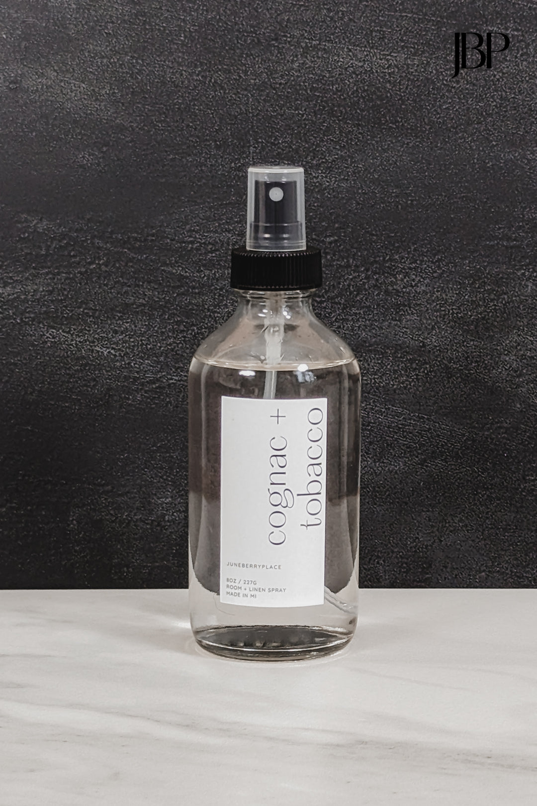 Cognac and Tobacco Room and Linen Spray in clear glass spray bottle by juneberryplace home fragrances