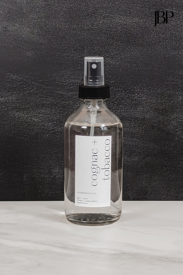 Cognac and Tobacco Room and Linen Spray in clear glass spray bottle by juneberryplace home fragrances
