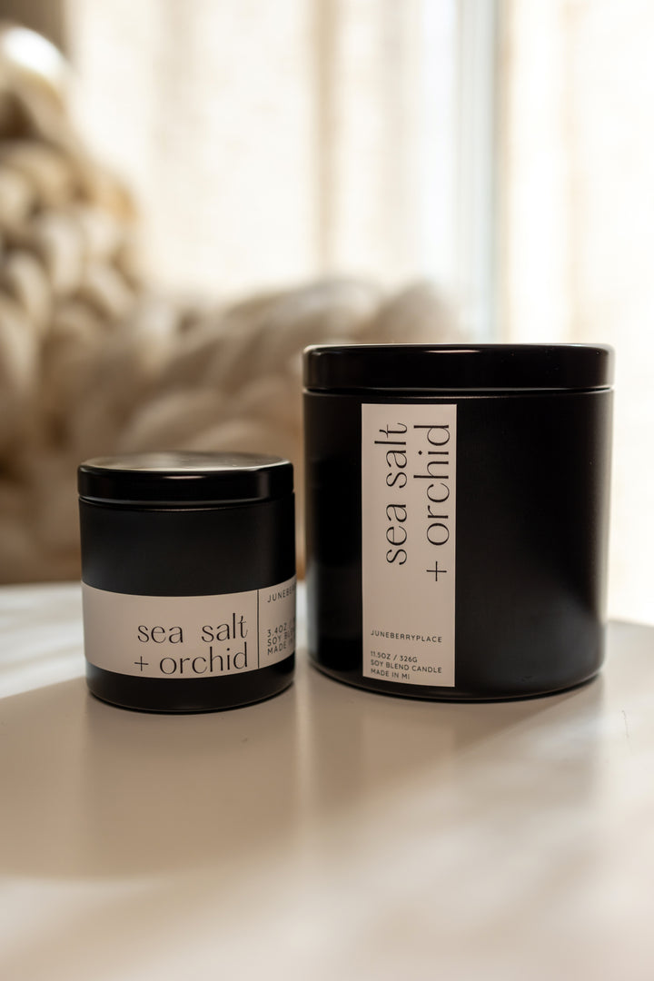 Sea Salt and Orchid Soy Candle in matte black vessel by juneberryplace home fragrances