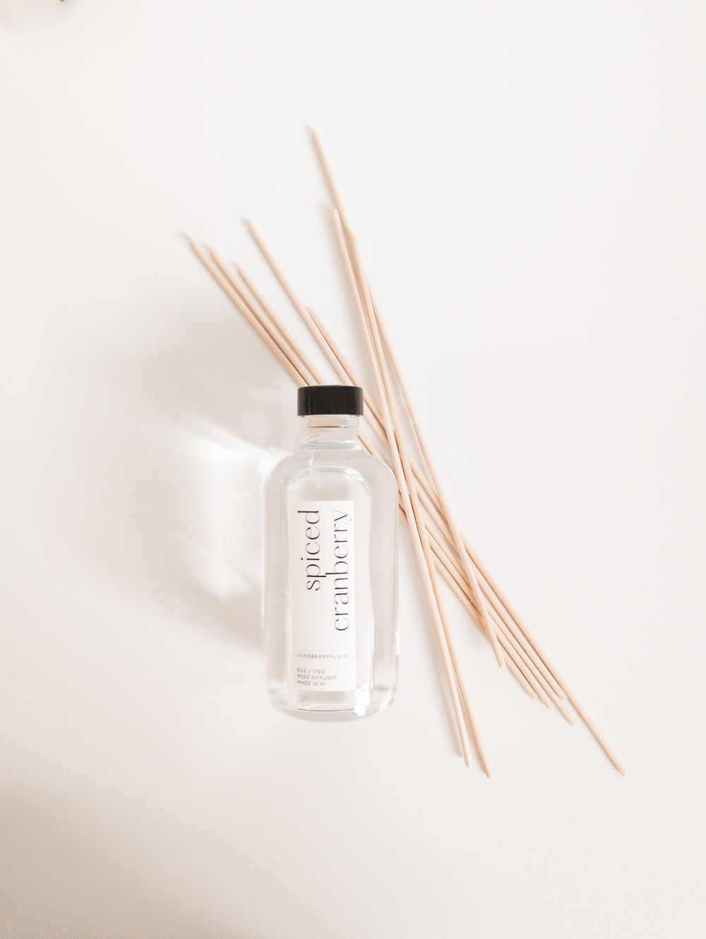 Spiced Cranberry reed diffuser: Winter delight with cranberry, blood orange, and spices. Modern clear glass, non-toxic formula. For home fragrance fans who love a clean aesthetic