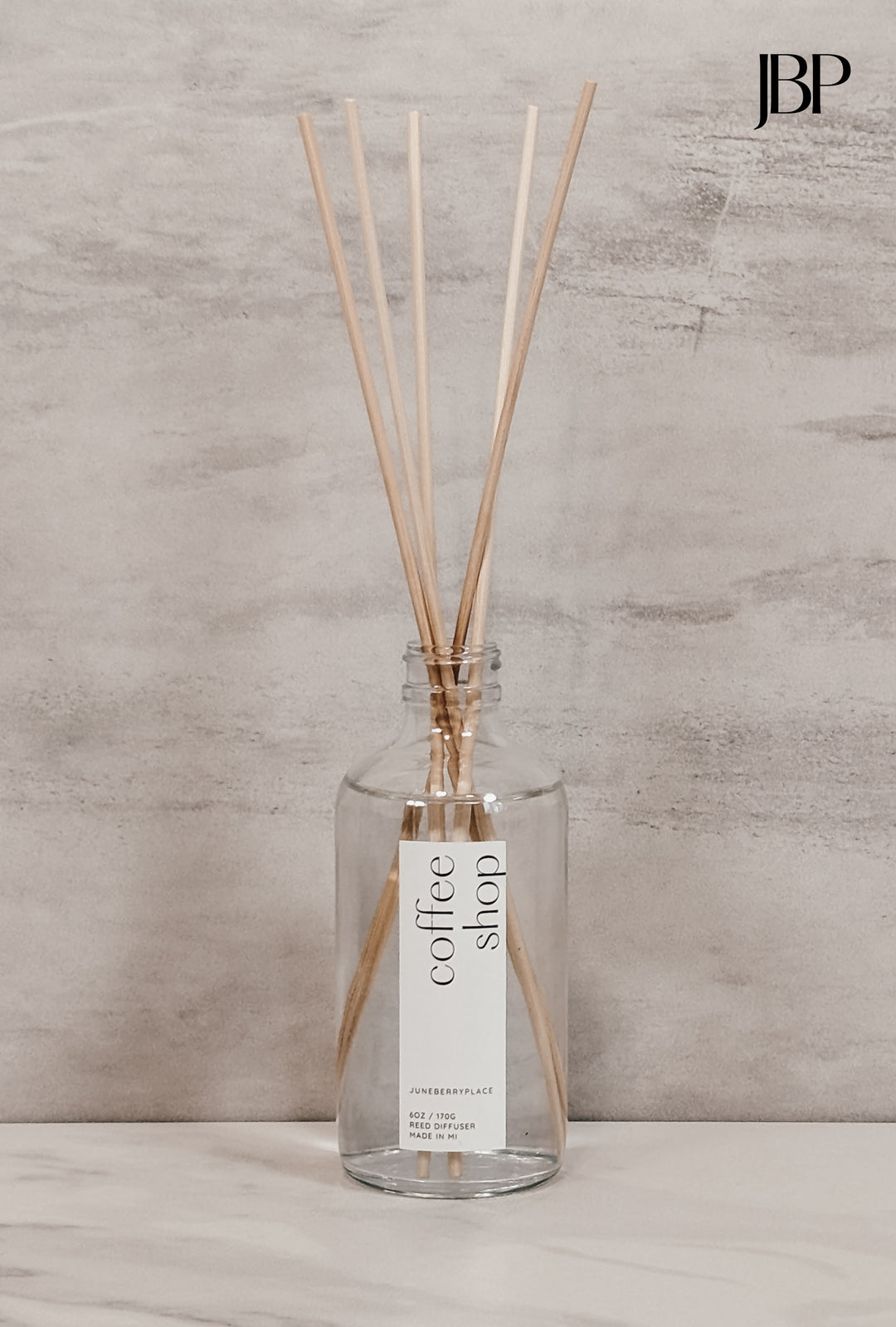 Coffee Shop Reed Diffuser in clear glass bottle with reeds by juneberryplace home fragrances