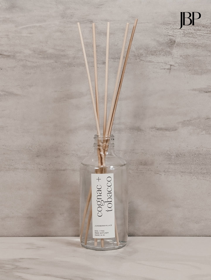 Cognac and Tobacco Reed Diffuser in clear glass bottle with reeds by juneberryplace home fragrances