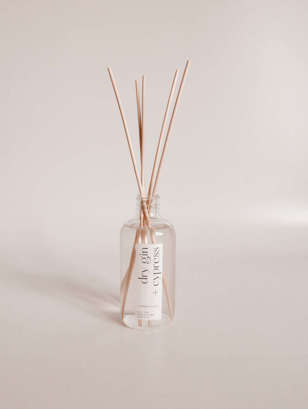Dry Gin and Cypress Reed Diffuser in clear glass bottle with reeds by juneberryplace home fragrances
