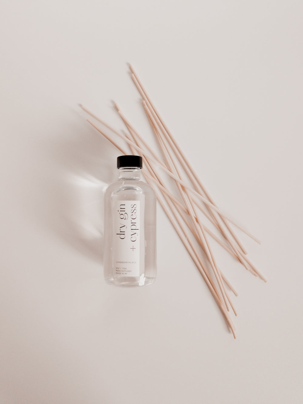 Dry Gin and Cypress Reed Diffuser with reeds in clear glass bottle with reeds by juneberryplace home fragrances