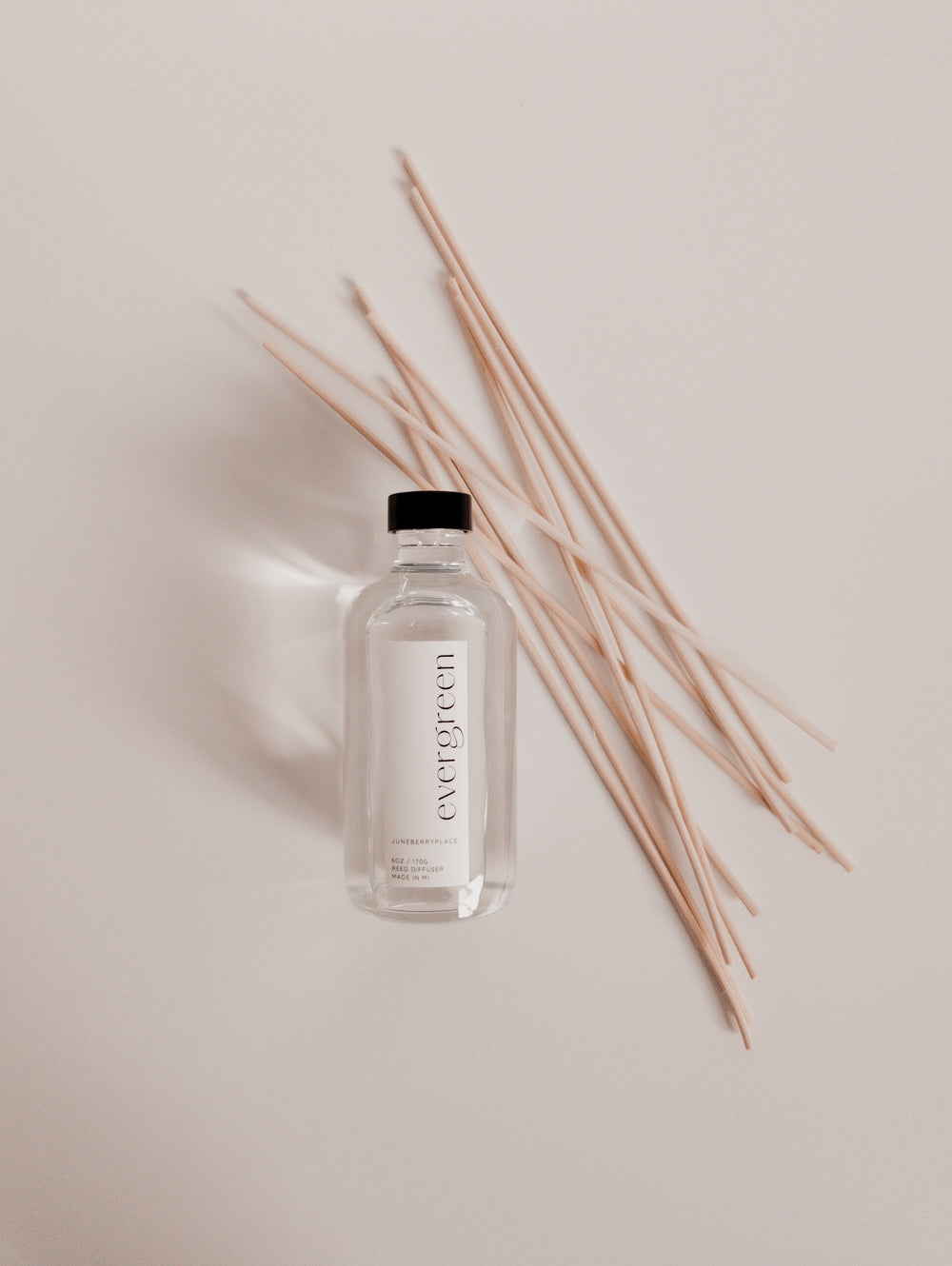 Evergreen Reed Diffuser with reeds in clear glass bottle with reeds by juneberryplace home fragrances