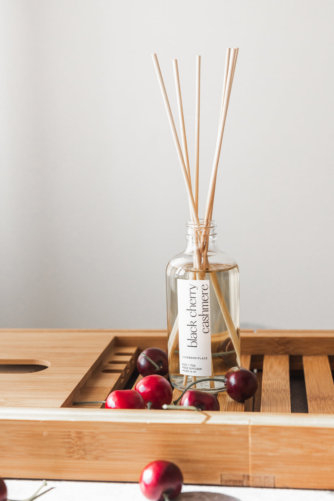 Black Cherry Cashmere Reed Diffuser in clear glass bottle with reeds by juneberryplace home fragrances